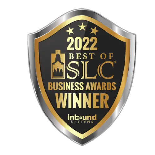 A gold and black shield-shaped badge reads 2022 Best of SLC Business Awards Winner with the Inbound Systems logo at the bottom. The badge features stars and a city skyline graphic.